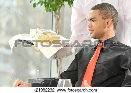 Stock Photo of man sitting in restaurant and looking at money.