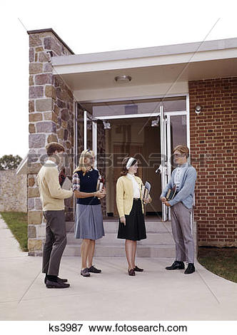 Picture of 1960s teen students standing at entrance to school boys.