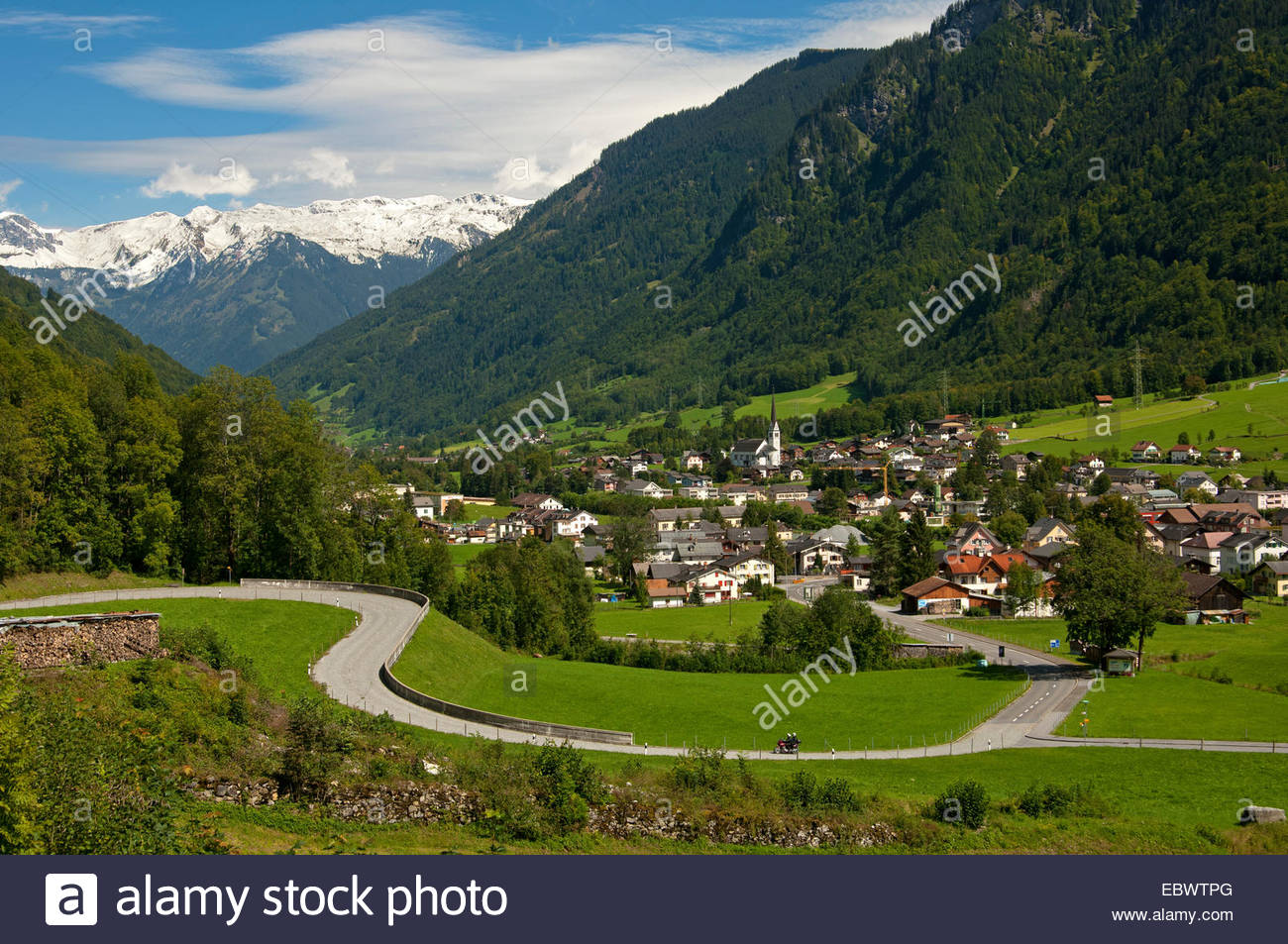 Winding road in front of the village of Linthal, Glarus Alps at.