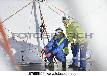 Stock Photograph of Emergency Response Team workers erecting tent.