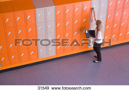 Stock Photograph of Girl opening locker in school corridor 31549.