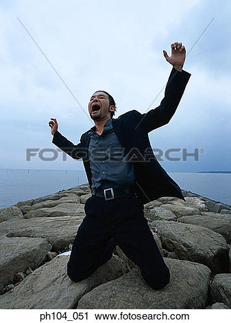 Stock Photography of Man kneeling, arms raised, shouting ph104_051.