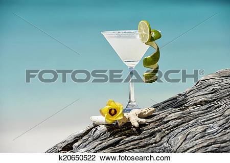 Stock Photo of Margarita with salt and lemon on glass rim.