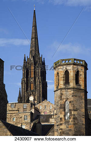 Picture of Clock tower of a cathedral and rooftops of various.