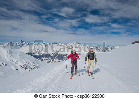 Stock Photography of Two elderly men practice ski mountaineering.