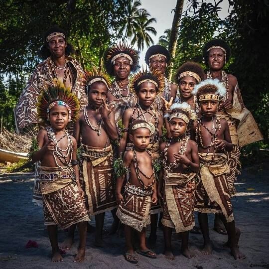 A Local family poses in traditional clothing in the village.