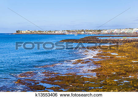 Stock Images of beach and village of Playa Blanca with the volcano.