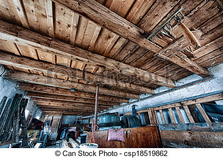 Stock Image of old farm storage room with junk and wooden ceiling.