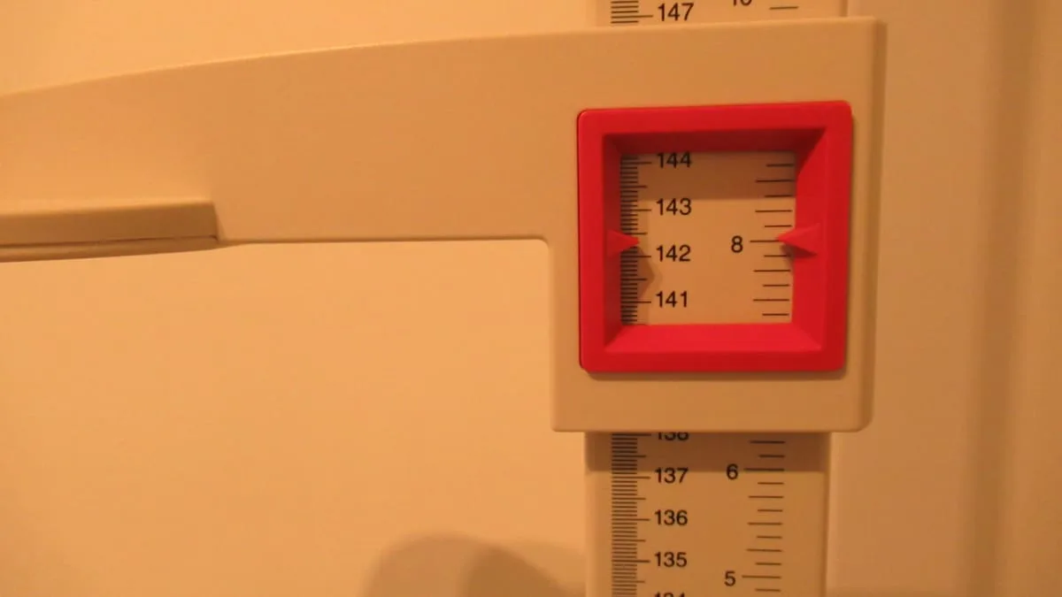 A stadiometer displaying the height 4 feet 8 inches