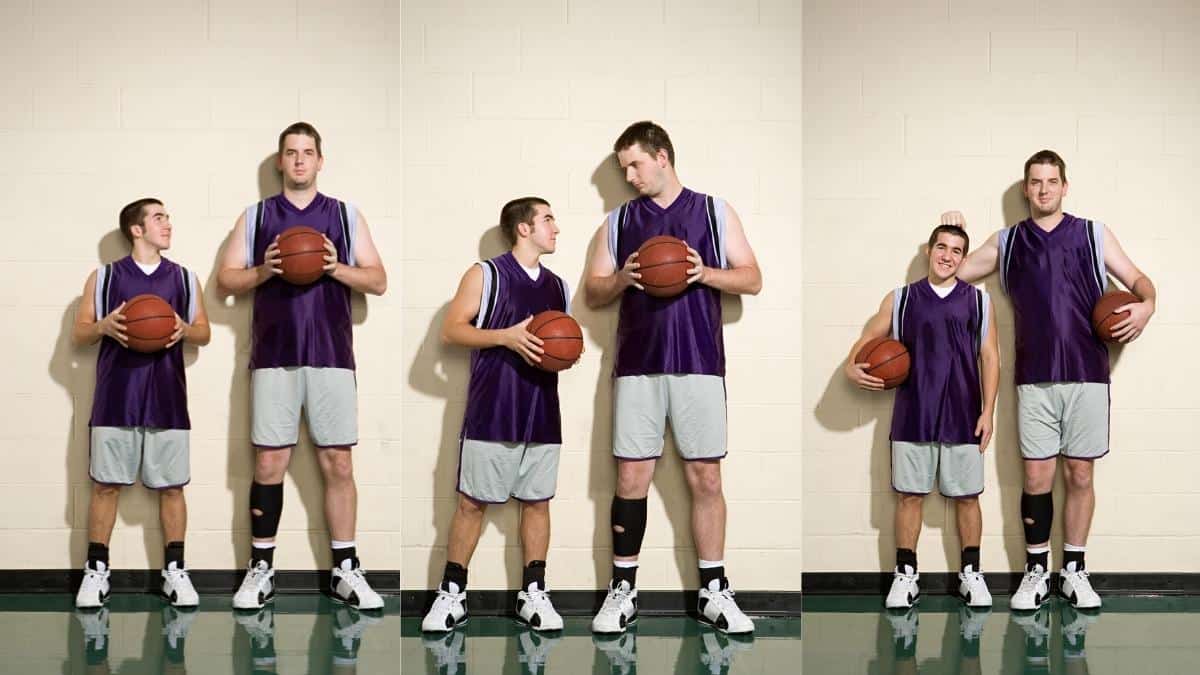 A tall 6'8 man standing next to his friend