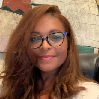 Felicia Lewis smiling, long auburn hair, glasses