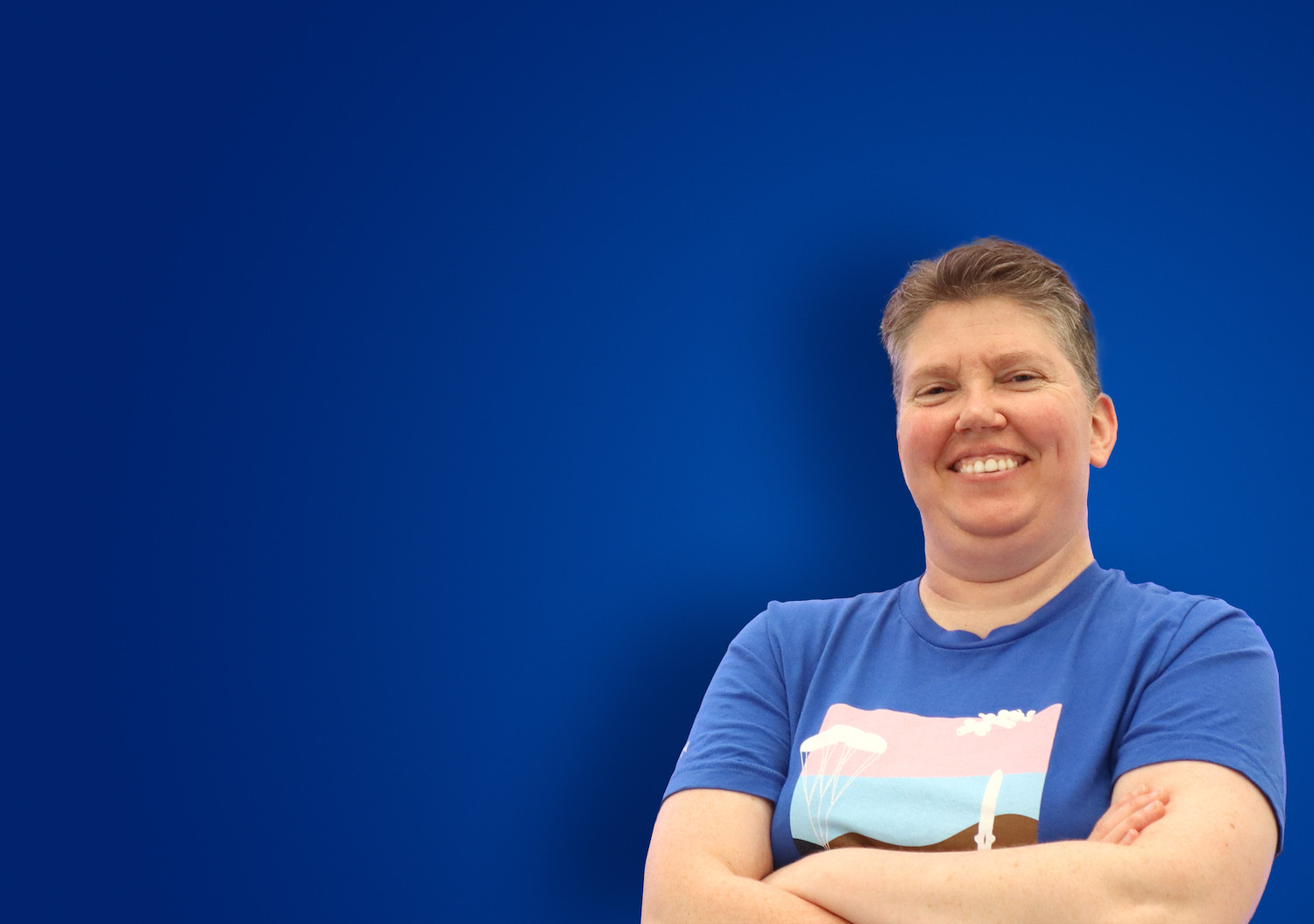 Person with a Blue Origin LGBTQ pride t-shirt