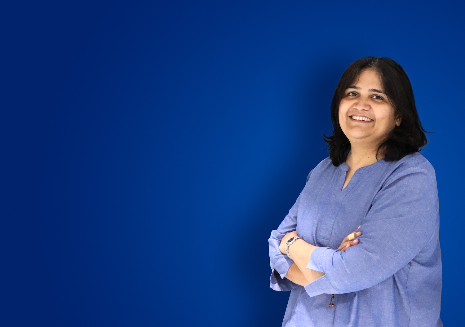 Smiling woman with her arms crossed