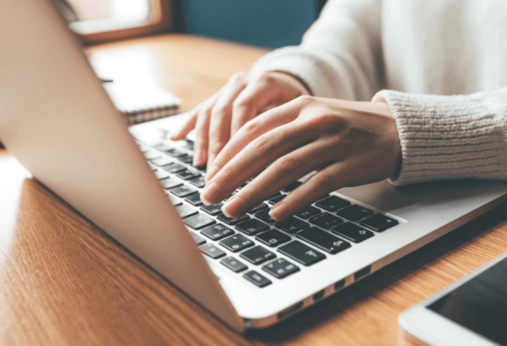 woman typing on laptop