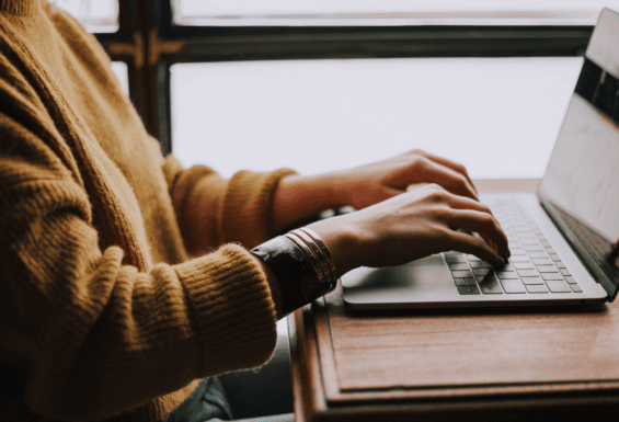 person typing on laptop