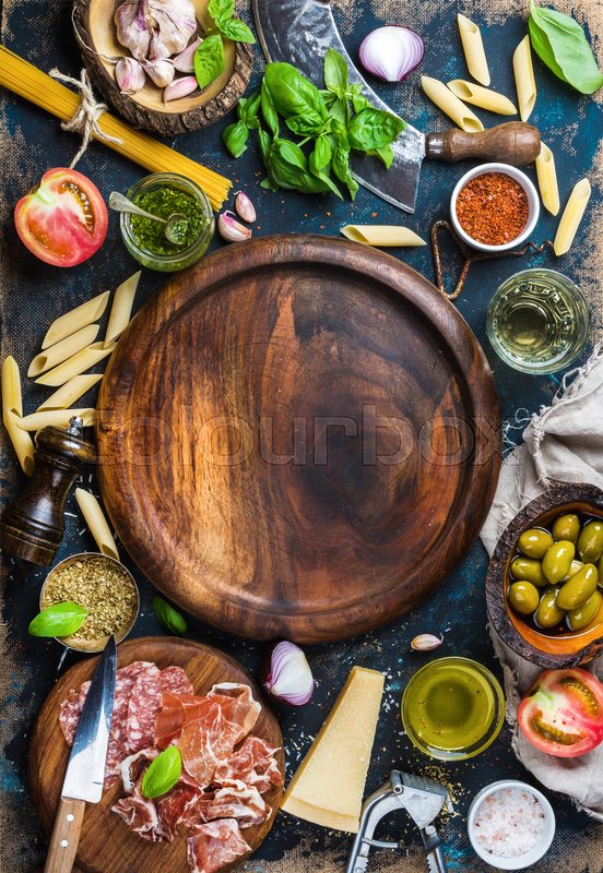 Italian food cooking ingredients on dark plywood background, copy space |  Stock image | Colourbox