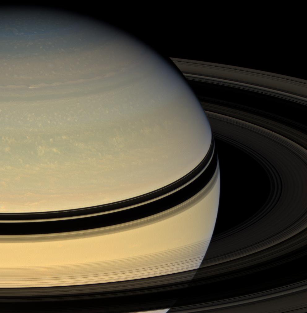 Stately Saturn sits surrounded by its darkened disk of ice. An increasing range of hues has become visible in the northern hemisphere as spring approaches and the ring shadows slide southward as seen by NASA's Cassini spacecraft.