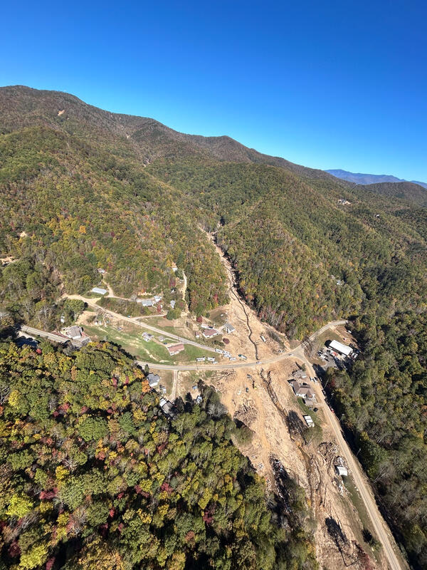 Damage caused by mudflows into Flat Creek near the Garren Creek Fire Station. Some of the initiating landslides are visible in the distance, upper left of photo.