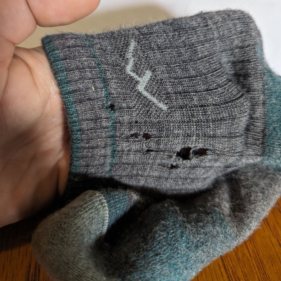 A closeup look at Laura's sock, with just a few tiny holes after enduring the elements