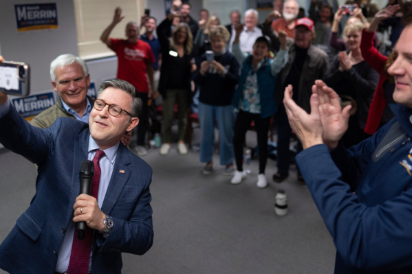 Speaker of the House Mike Johnson, R-La., second from left, joined by Rep. Bob Latta, R-Ohio, left, and Ohio state Rep. Derek Merrin, right, takes a selfie to send to Republican presidential nominee former President Donald Trump as he speaks during a campaign event at the Lucas County Republican Party headquarters in Holland, Ohio, Saturday, Oct. 26, 2024. (AP Photo/Carolyn Kaster)