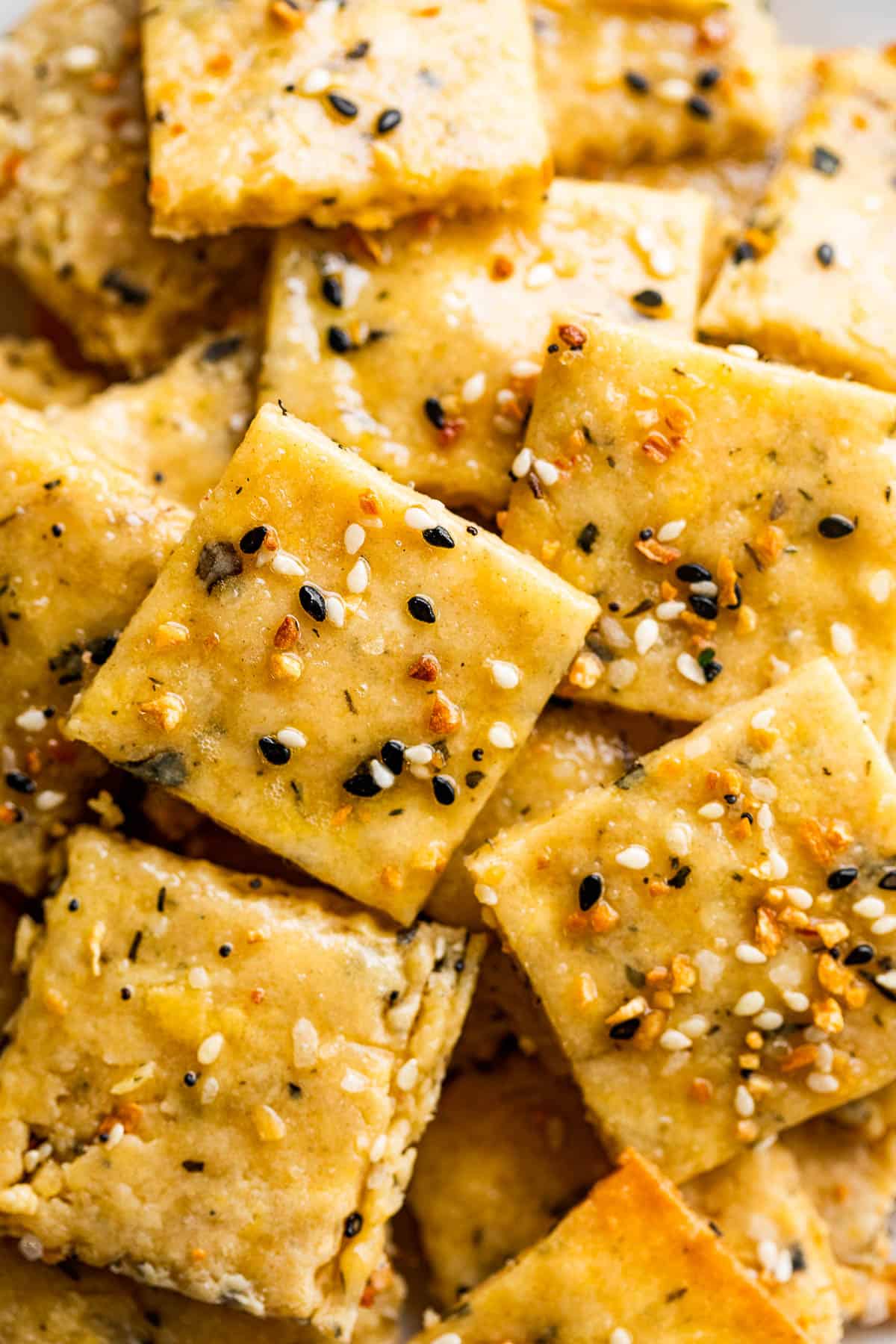 Close-up picture of homemade crackers topped with everything bagel seasoning.