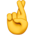 Bagaimana Crossed Fingers emoji terlihat di Apple.