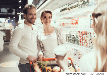 Family of Three in Supermarket in Dairy Department 42358201