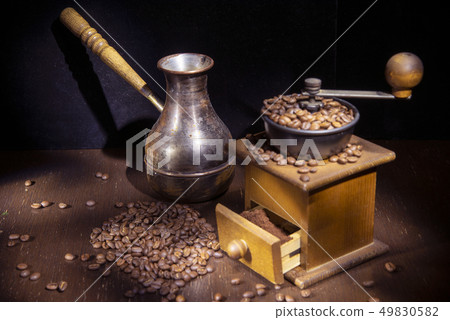 The photo was taken in the technique of Light brush . On the table are a coffee grinder and a Turk 49830582