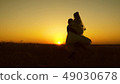 Young bride and groom circling on background of romantic red sunset. Honeymoon. The relationship 49030678