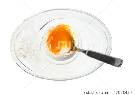 top view of soft egg with spoon in glass egg cup 57038439