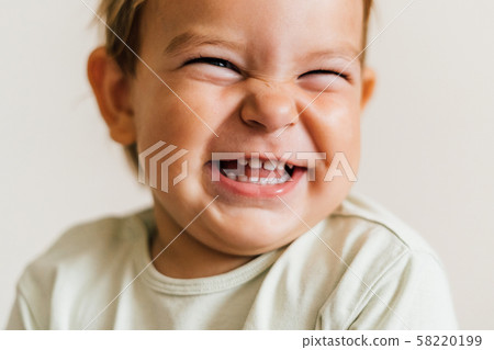 Excited face of a small baby toddler on white background. Pure joy. Close up portrait 58220199