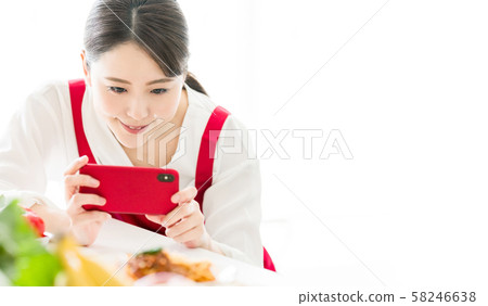 A woman shooting a dish 58246638