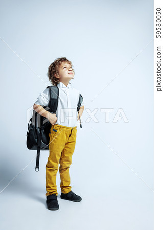 Pretty young boy in casual clothes on white studio background 59580050