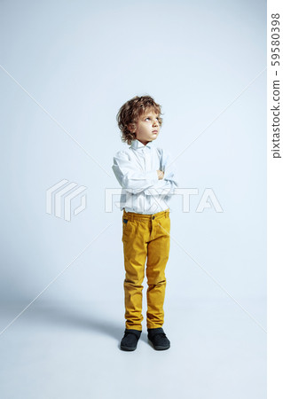 Pretty young boy in casual clothes on white studio background 59580398