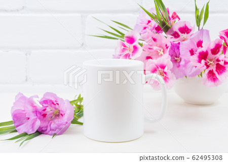 White coffee mug mockup with pink godetia flowers 62495308