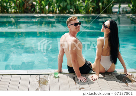 Happy couple resting at swimming pool 67187801