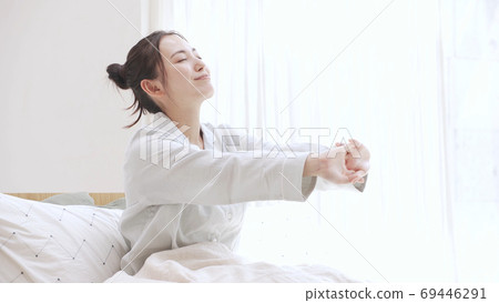 Young woman in pajamas waking up 69446291