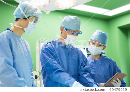 Medical staff performing surgery 69479939