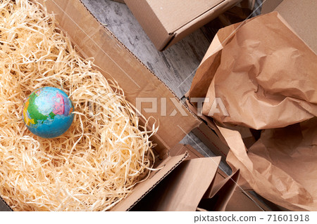 Globe in opened parcel. 71601918