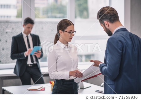 Woman and man discussing, colleague by the window 71258936