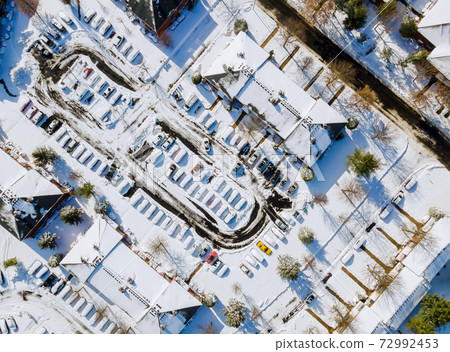 Aerial view apartment buildings complex in residential houses neighborhood roof houses covered snow 72992453