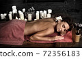 Massage woman back in beauty spa with candlelight 72356183