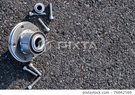 Auto mechanic. Set of new metal car part. Auto motor mechanic spare or automotive piece isolated on black ground asphalt texture. Tarmac dark grey grainy road. 76662566