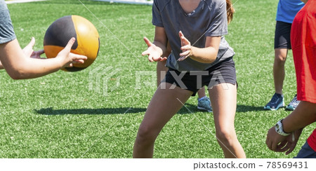 Throwing and catching a medicine ball at practice 78569431