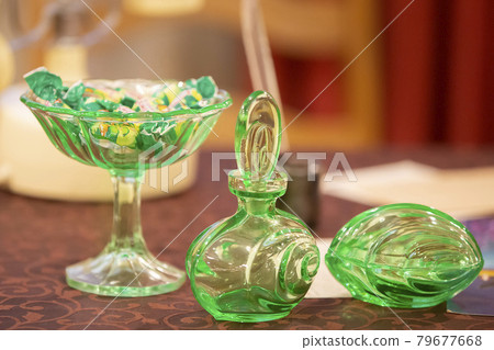 Glassware. Glass green dishes are on the table. 79677668