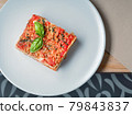 Piece of delicious lasagna with basil leaf on 79843837