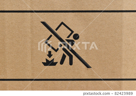 Close Up of cardboard box with packaging symbols as background. 82423989