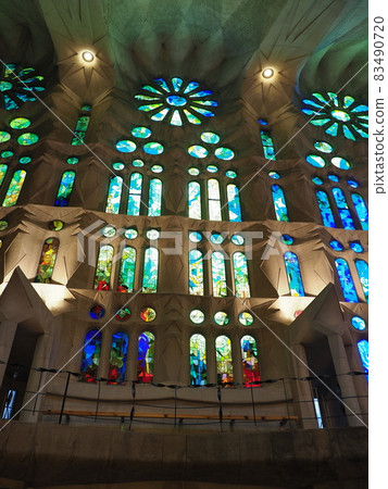 Stained glass windows at basilica in Barcelona city, Spain - vertical 83490720