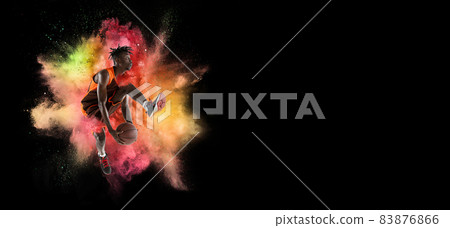 Creative collage of young man, professional backetball player training isolated over colorful powder explosion on black background. Flyer 83876866