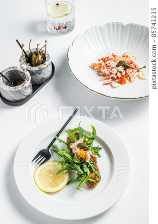 Salad with Crab meat on a kitchen table. White background. Top view 85741215